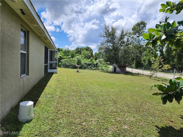 915 Alvin Ave, Lehigh Acres, FL 33971 - view of yard featuring an outbuilding and a storage shed