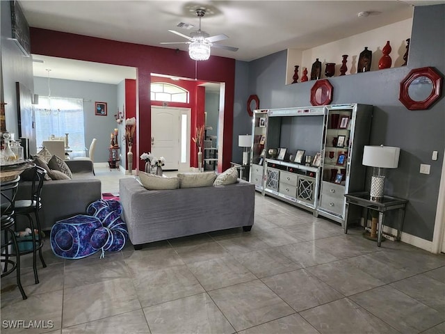 915 Alvin Ave, Lehigh Acres, FL 33971 - living room with visible vents, baseboards, and ceiling fan with notable chandelier