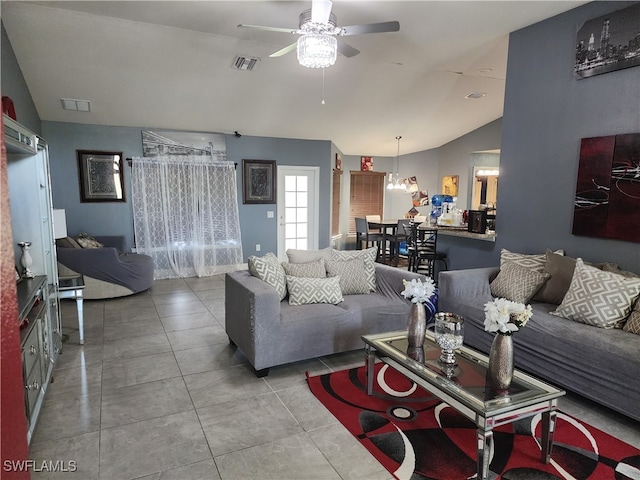 tiled living room featuring ceiling fan and vaulted ceiling