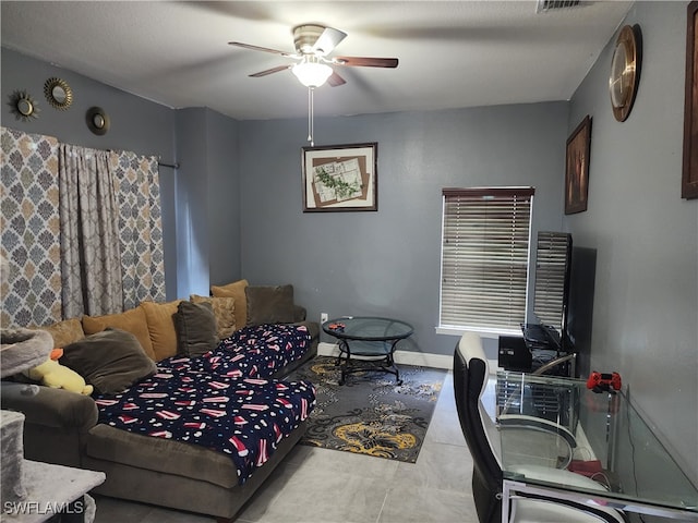 living room with ceiling fan and tile patterned flooring