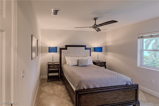 bedroom with ceiling fan and light tile patterned flooring