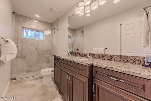 bathroom featuring tile patterned flooring, vanity, toilet, and an enclosed shower