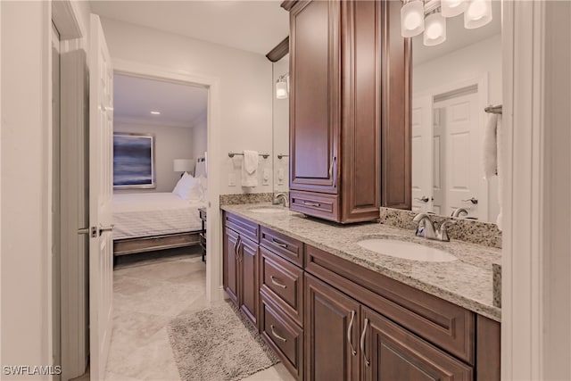 bathroom featuring tile patterned flooring, vanity, and crown molding