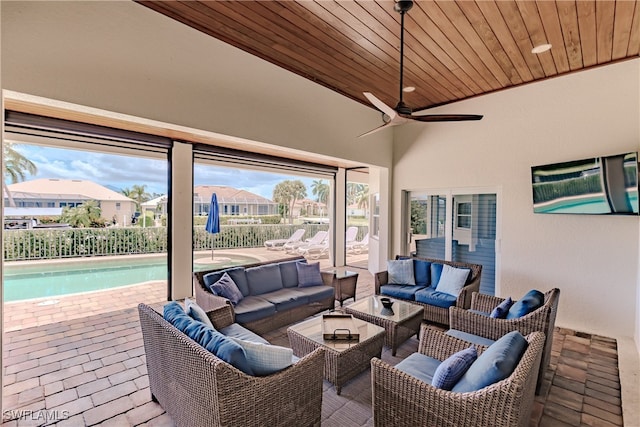 sunroom featuring wood ceiling, vaulted ceiling, and ceiling fan