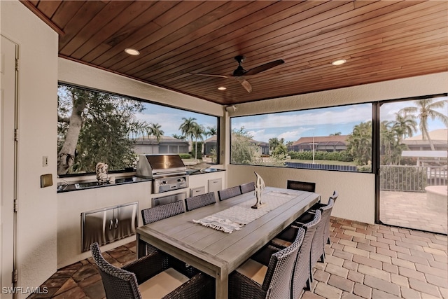 view of patio featuring grilling area, an outdoor kitchen, and ceiling fan