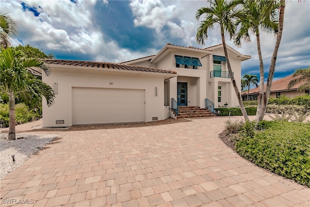 mediterranean / spanish-style home featuring a balcony and a garage