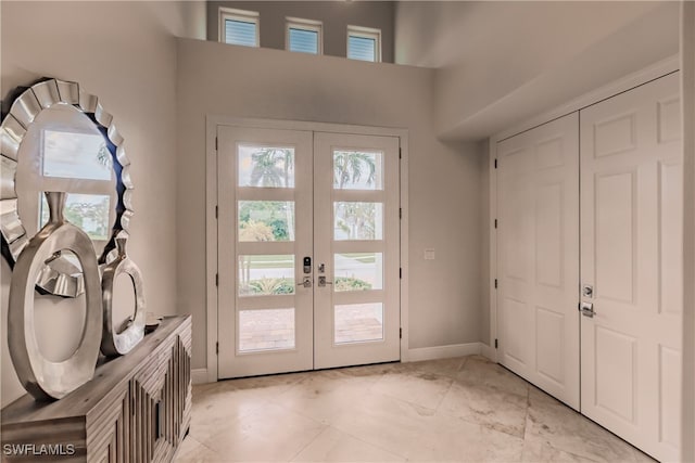 entryway featuring french doors and light tile patterned floors