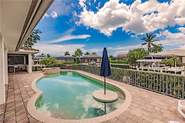 view of swimming pool featuring an in ground hot tub and a patio