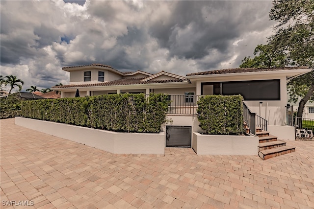 mediterranean / spanish-style home featuring a patio