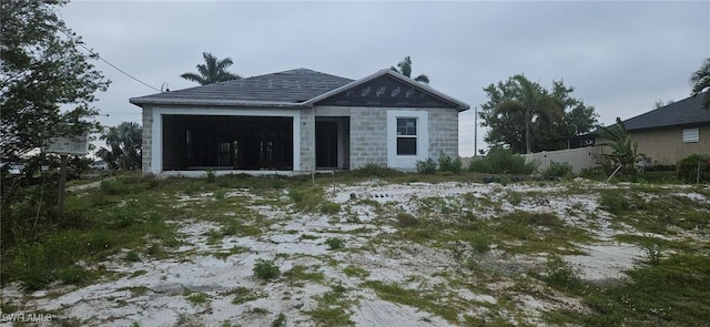 view of front of property with fence and a sunroom