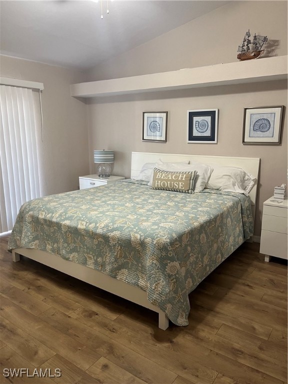 bedroom featuring dark wood-type flooring and lofted ceiling