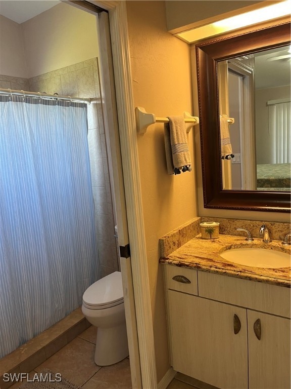 bathroom featuring tile patterned flooring, vanity, toilet, and a shower with curtain