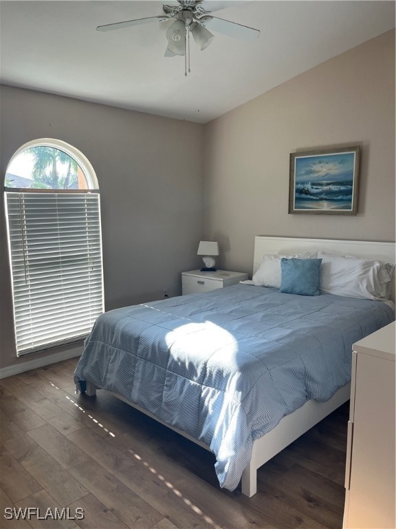 bedroom featuring lofted ceiling, ceiling fan, and dark hardwood / wood-style flooring