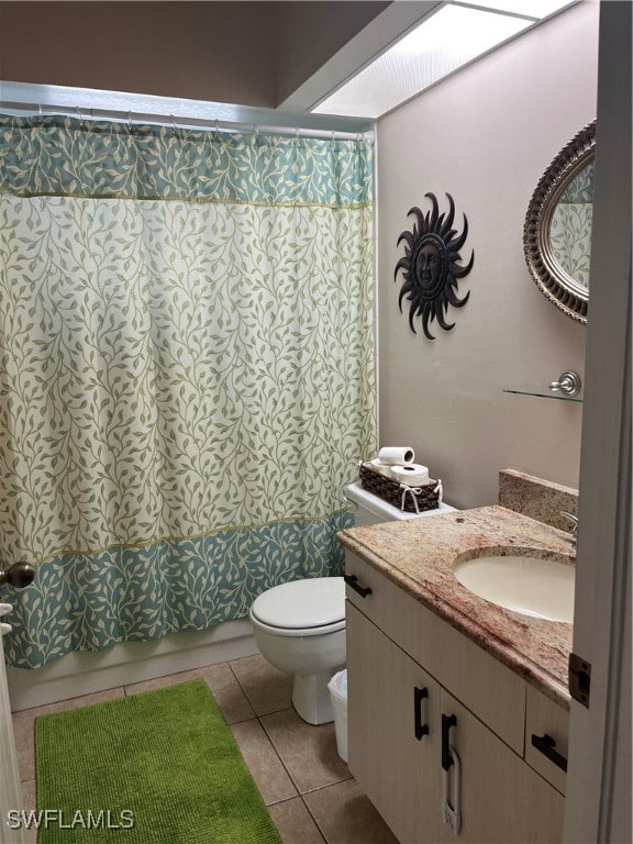 full bathroom featuring tile patterned flooring, toilet,  shower combination, and vanity