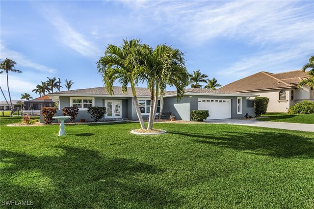 ranch-style home with a garage and a front lawn