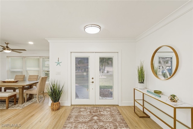 doorway to outside with baseboards, french doors, light wood-style flooring, and crown molding