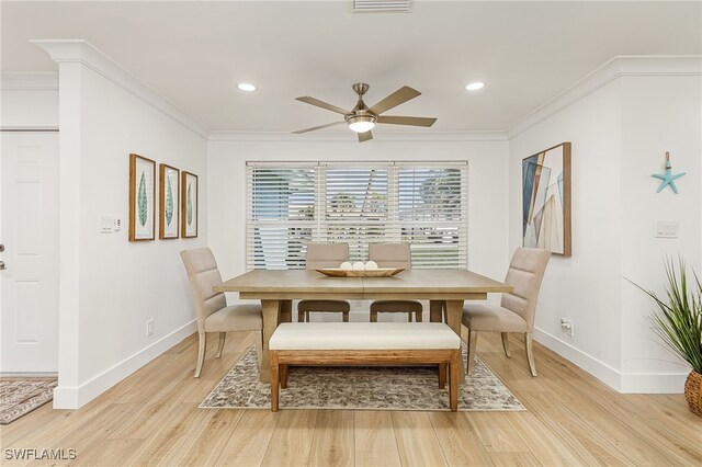 dining area featuring light hardwood / wood-style floors, ornamental molding, and ceiling fan