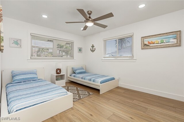 bedroom with light hardwood / wood-style flooring and ceiling fan