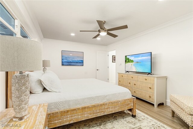 bedroom with baseboards, wood finished floors, a ceiling fan, and crown molding