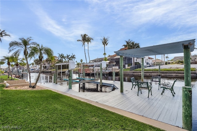 view of dock with a water view, boat lift, a residential view, and a lawn