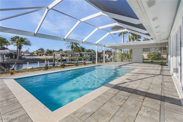 view of swimming pool featuring glass enclosure and a patio area