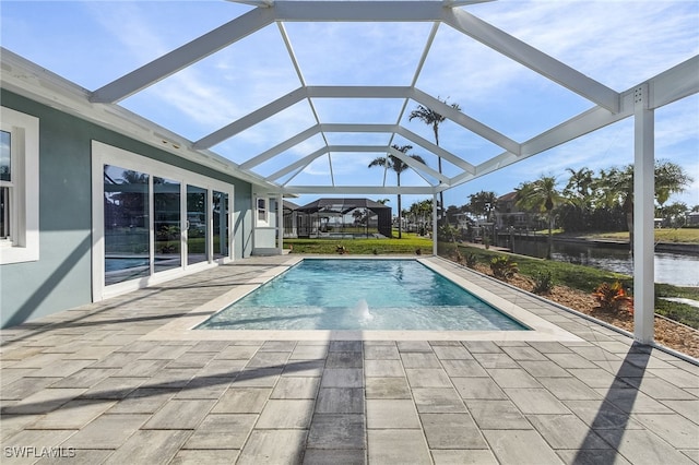 outdoor pool featuring a patio and glass enclosure