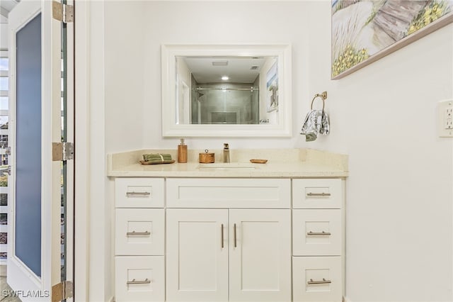 bathroom with an enclosed shower and vanity