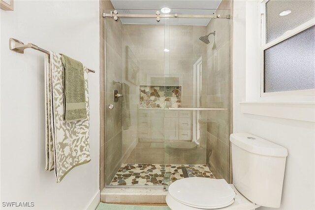 bathroom featuring toilet and walk in shower