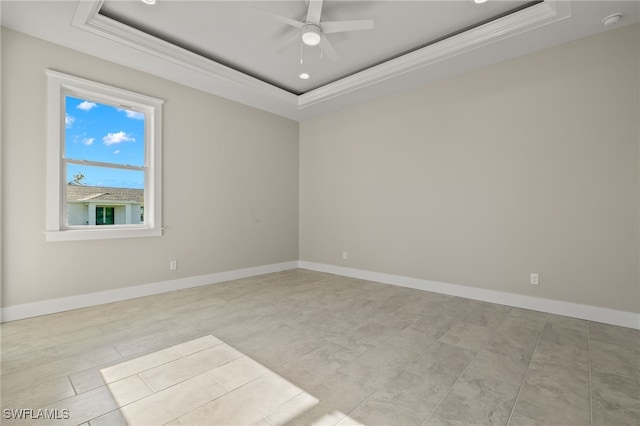 unfurnished room with light tile patterned flooring, ceiling fan, and a tray ceiling