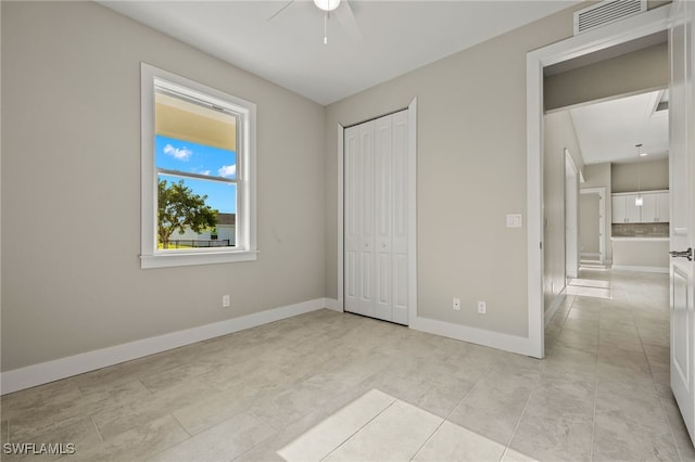 unfurnished bedroom with ceiling fan and light tile patterned flooring