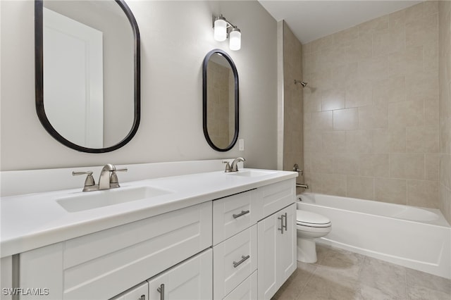 full bathroom featuring tiled shower / bath combo, tile patterned floors, toilet, and vanity