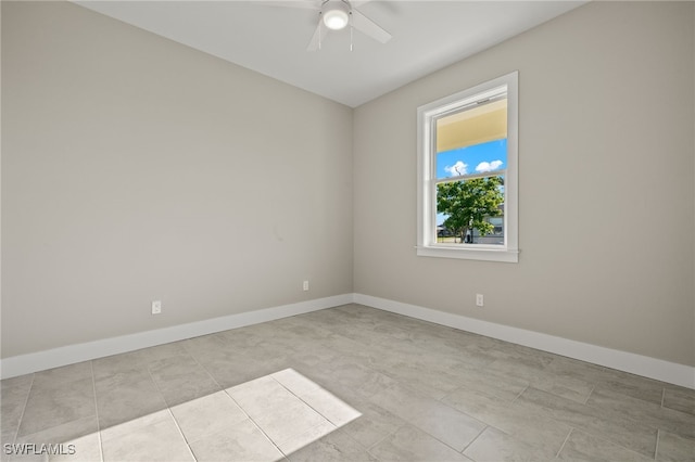 empty room featuring ceiling fan and light tile patterned floors