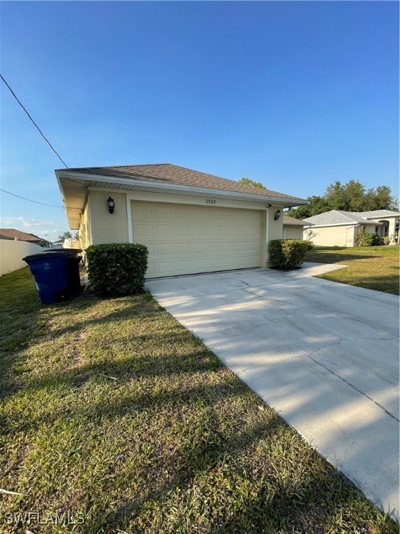 exterior space featuring a garage and a yard