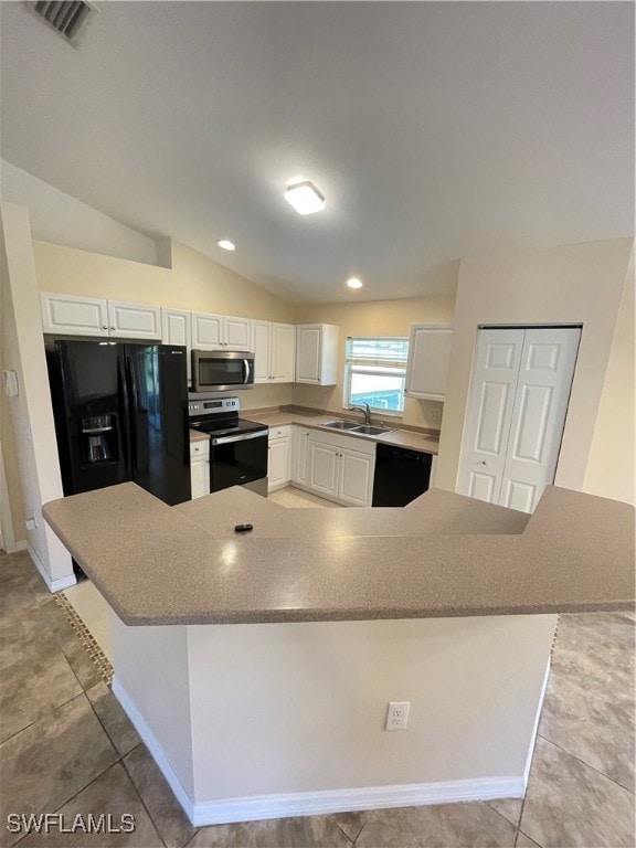 kitchen with sink, black appliances, white cabinetry, and lofted ceiling