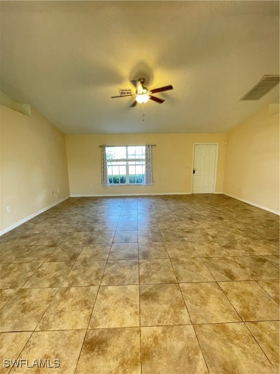 tiled empty room with ceiling fan