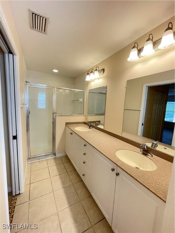 bathroom featuring tile patterned floors, vanity, and walk in shower