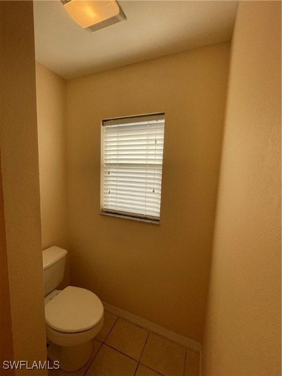 bathroom featuring tile patterned flooring and toilet