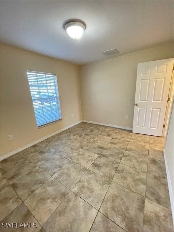 unfurnished room with light tile patterned floors