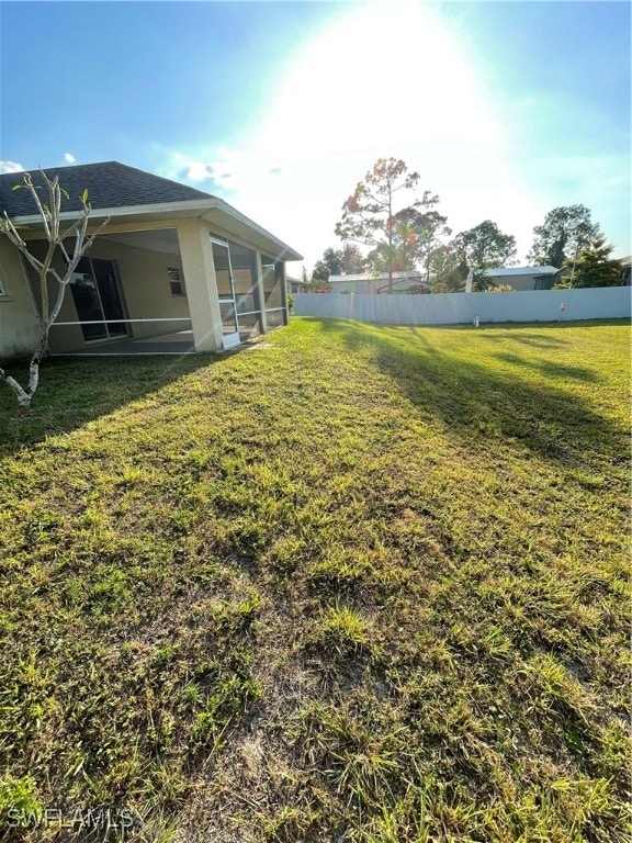 view of yard with a sunroom