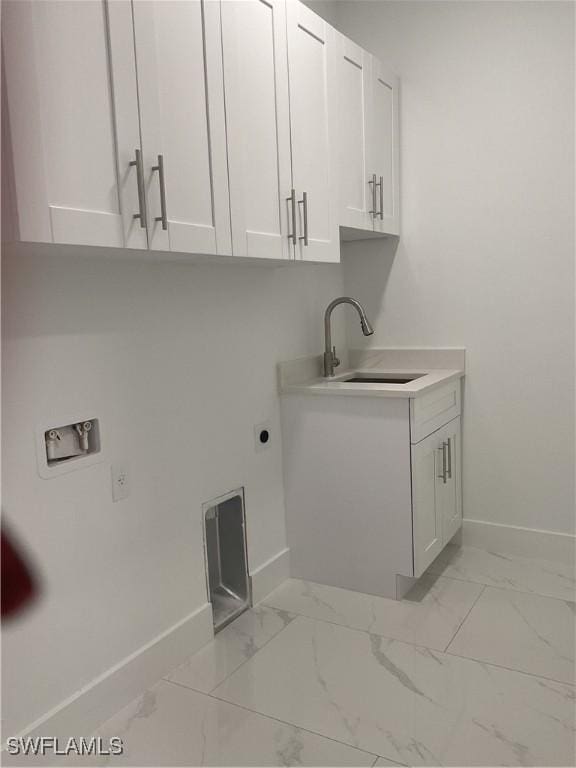 laundry area featuring cabinets, hookup for a washing machine, hookup for an electric dryer, and sink