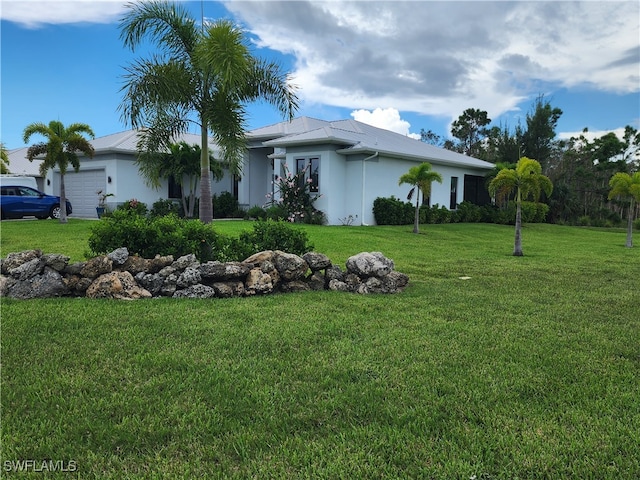 view of front facade featuring a garage and a front lawn