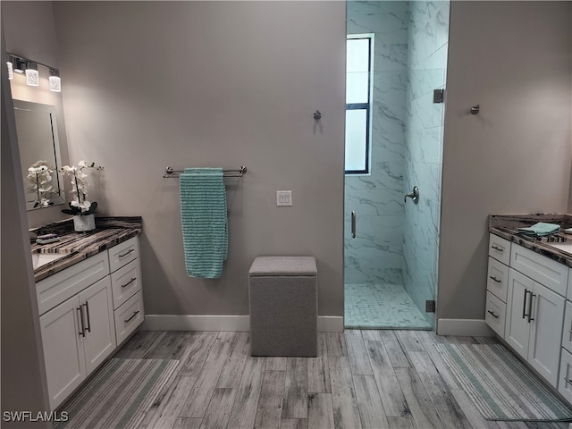 bathroom with vanity, hardwood / wood-style floors, and a shower with door