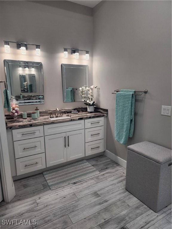 bathroom with vanity and wood-type flooring