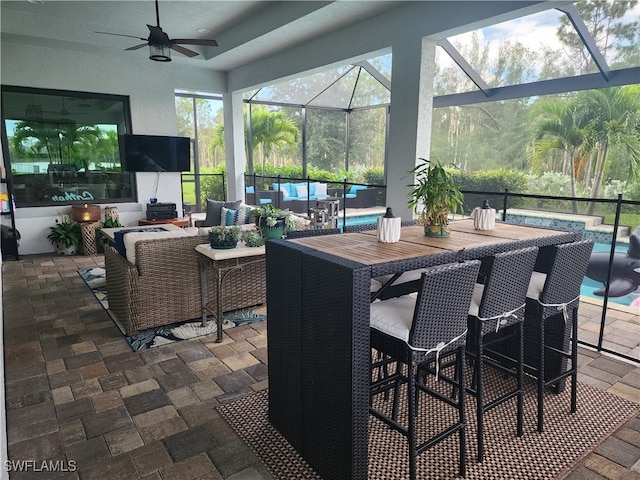 sunroom with ceiling fan and a healthy amount of sunlight