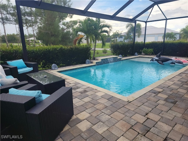 view of pool featuring a lanai, a patio, and pool water feature