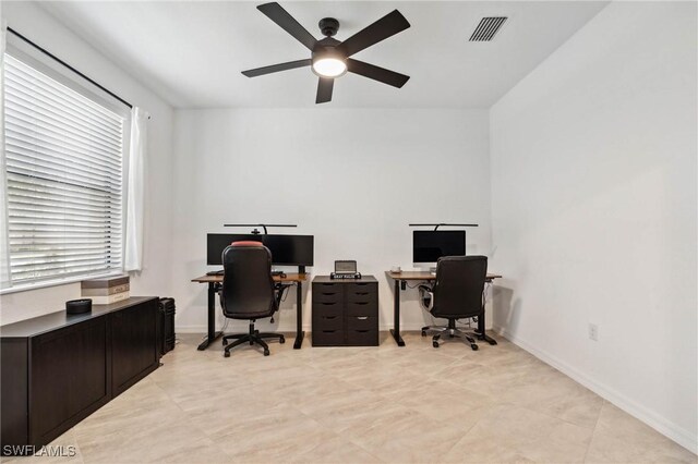 tiled office space featuring ceiling fan