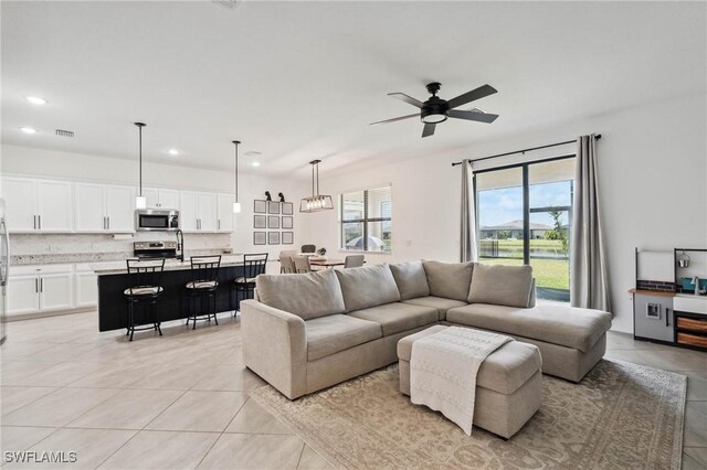 tiled living room with ceiling fan