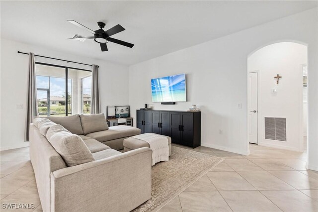 living room with ceiling fan and light tile patterned floors