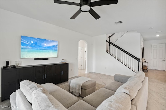 tiled living room with ceiling fan