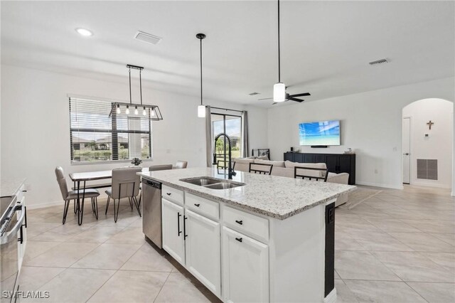 kitchen with a kitchen island with sink, light tile patterned floors, dishwasher, sink, and ceiling fan